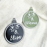 Grüne Mama-Kugel und schwarze Elisa-Kugel nebeneinander.